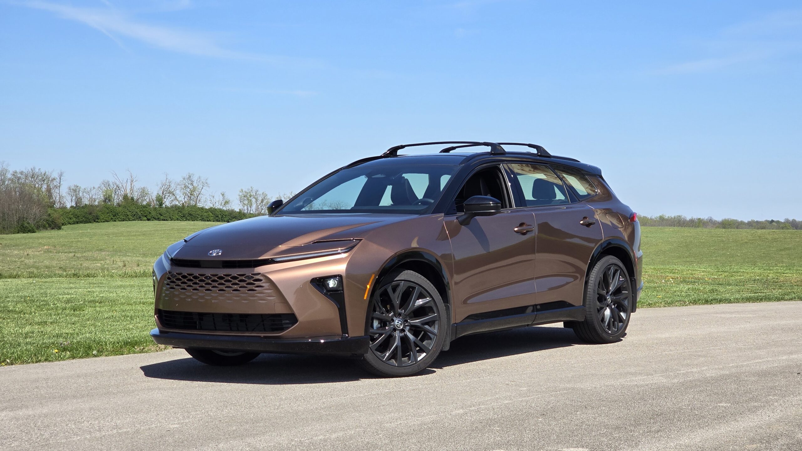 Bronze Toyota Crown Signia crossover parked outdoors in a front three-quarter view