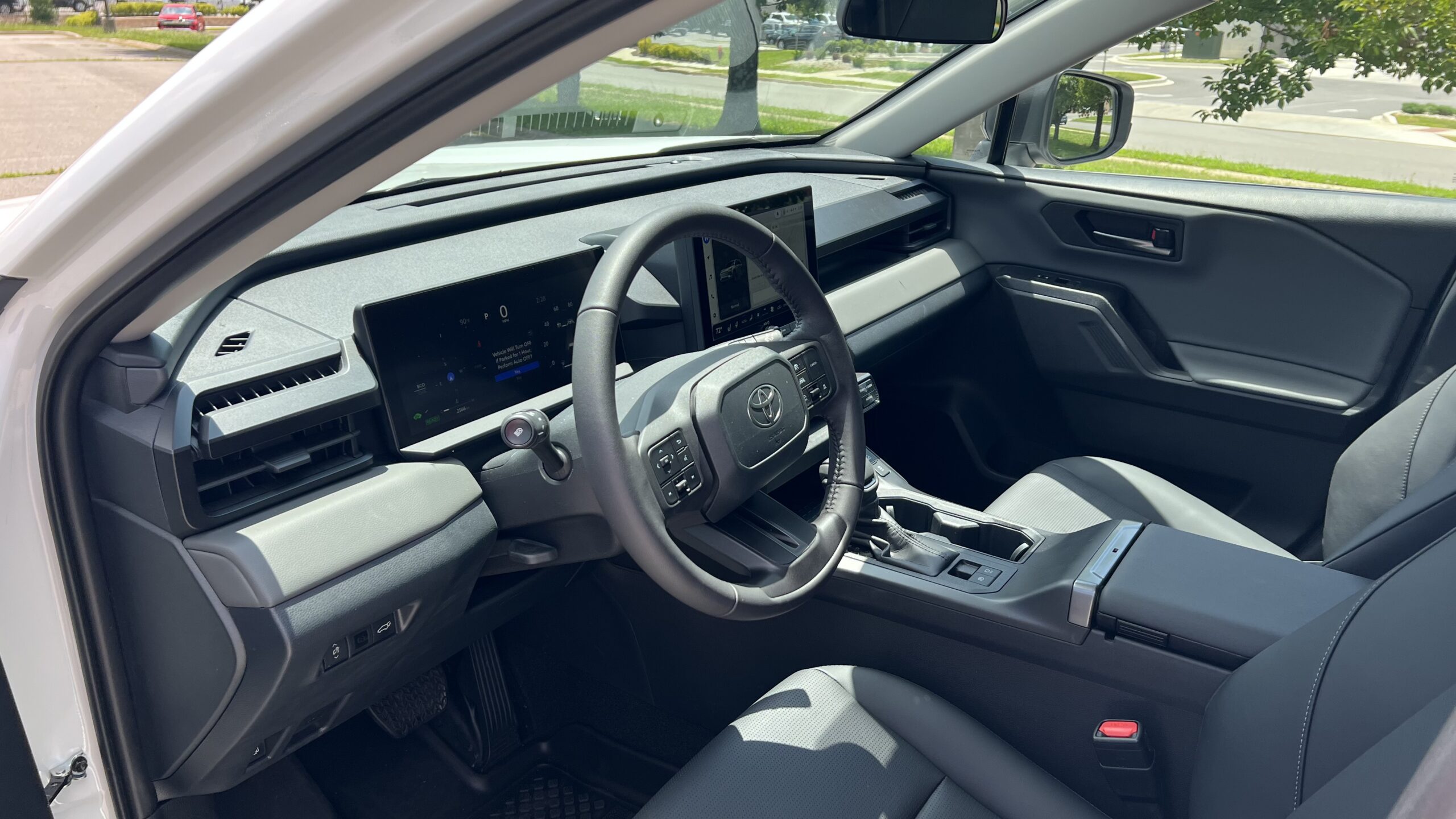 A view of the 2026 Toyota RAV4 XLE Premium interior from the driver’s seat, featuring the SofTex-trimmed seats with 8-way power adjustability and the central touchscreen.